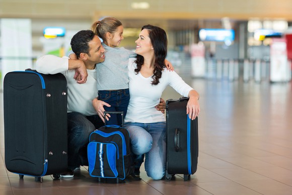 Family at airport preparing for flight.