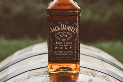 Bottle of Jack Daniel's whiskey sitting on a barrel