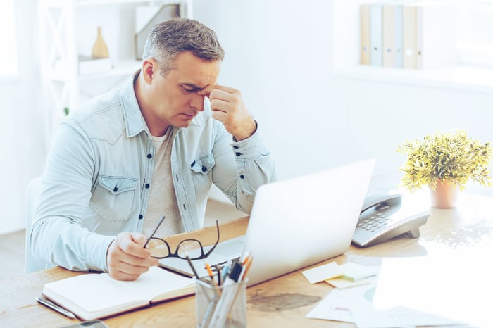 Frustrated man sitting in front of computer