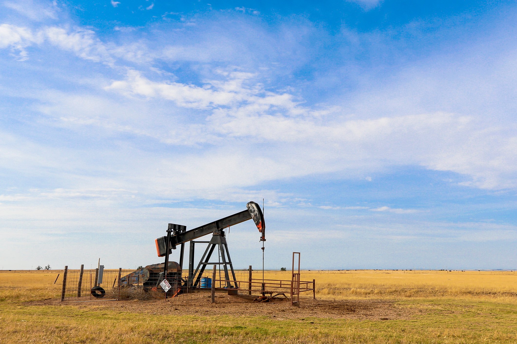 An oil derrick operating on the plains of the Oklahoma panhandle.