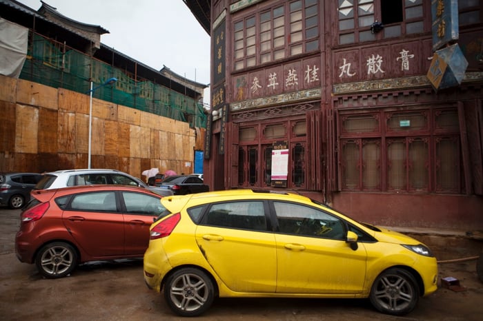 A yellow Ford Fiesta parked near a building in China