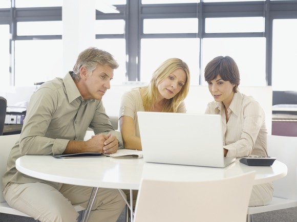 Senior couple working with adviser.