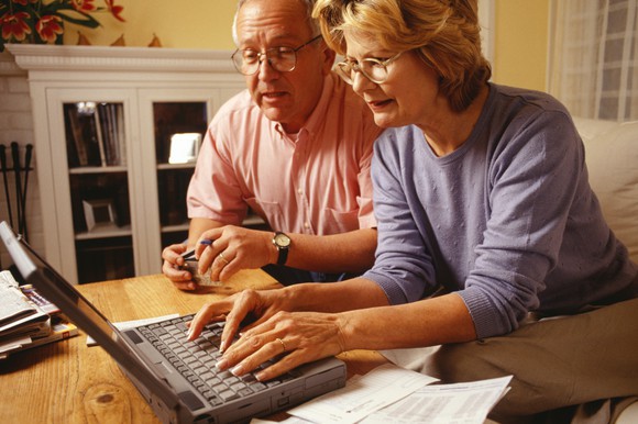 Senior couple using a laptop.