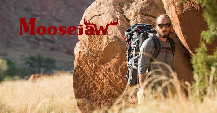 Man hiking in the wilderness amid tall grass