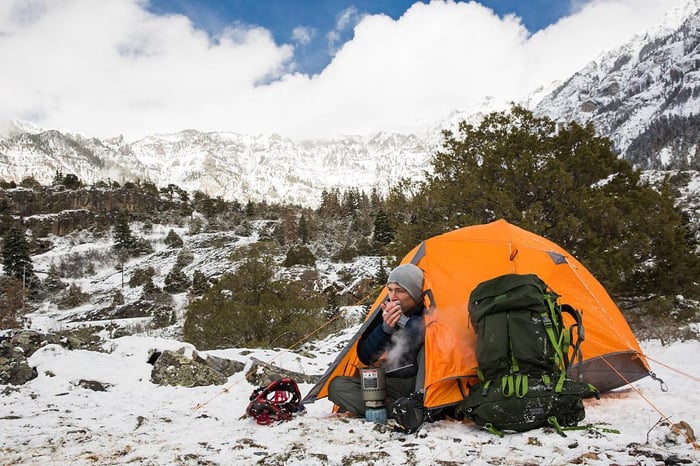 Camping in the mountains during winter with snow on the ground