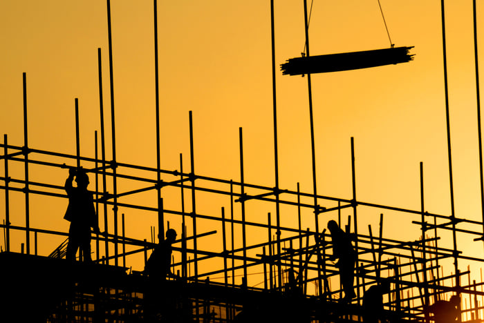 Construction workers at sunset