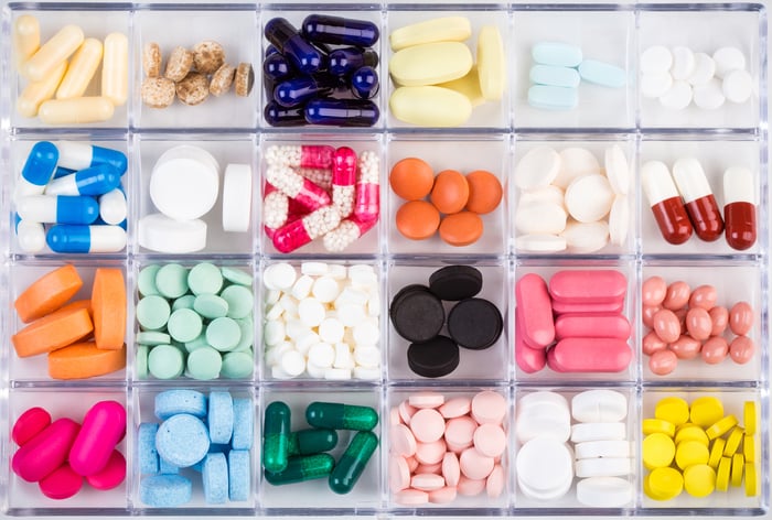 Divided container of many multicolored pills