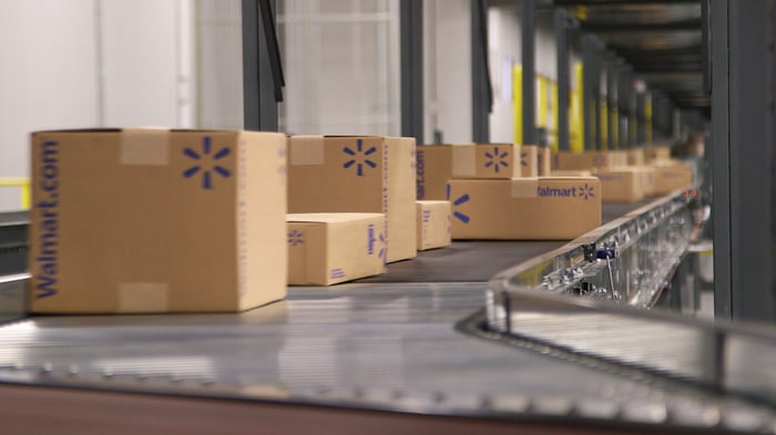 Wal-Mart boxes coming down a conveyor belt.