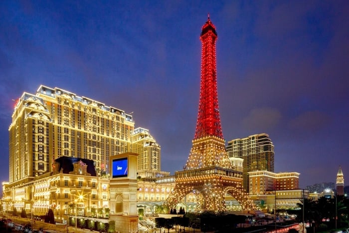 A view of the scale Eiffel Tower in front of Las Vegas Sands Parisian resort at night.