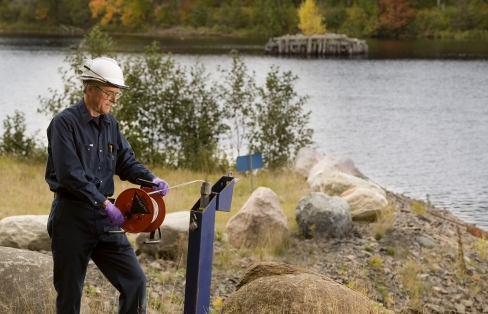 A Cameco employee sampling water.