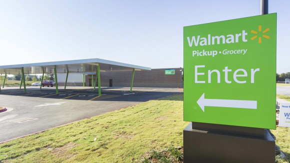 A sign guiding shoppers to Wal-Mart's grocery pickup station
