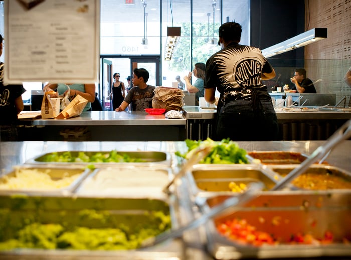 A Chipotle Mexican Grill restaurant as seen from behind the serving station.