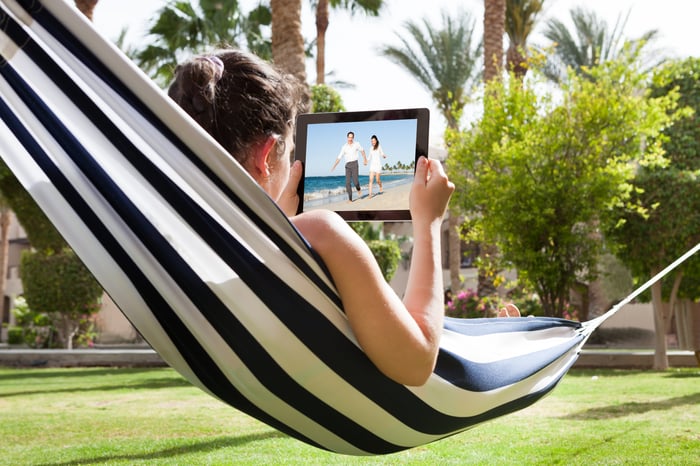 Young woman watching video on digital tablet