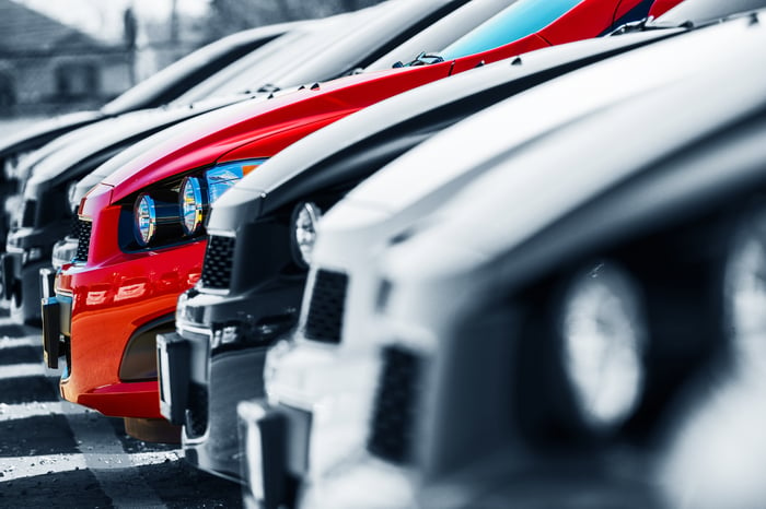 A row of vehicles at a dealership lot.