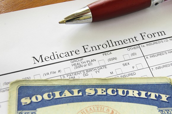 Social Security card on top of Medicare enrollment form.