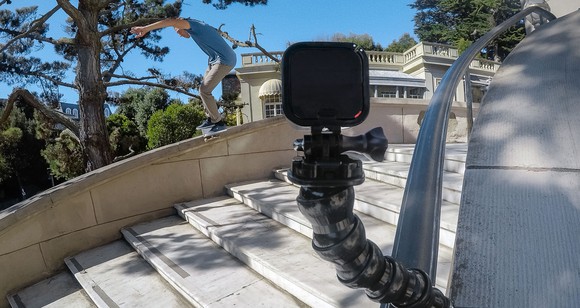 A GoPro recording a skateboarding doing tricks down a stairway.