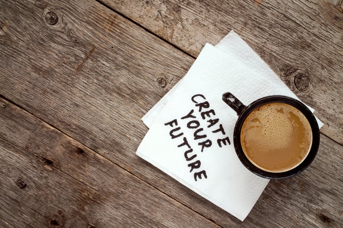 "create your future" written on a napkin under a mug of coffee