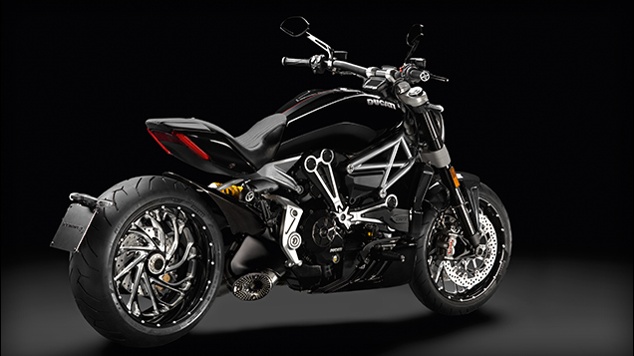 A sleek Ducati sports bike in black against a black background