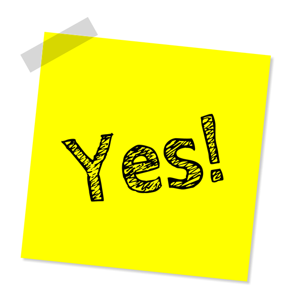 Yellow sticky note that says "Yes!" taped to a surface