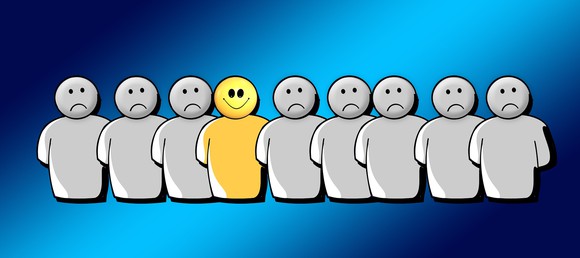 Cartoonish graphic of a row of people all frowning, except the smiling person in the middle