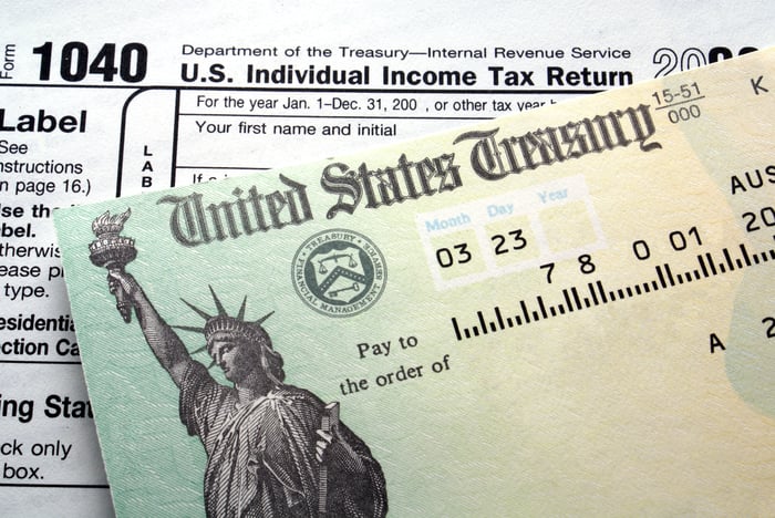 Close up of portion of tax refund check, on top of 1040 tax form