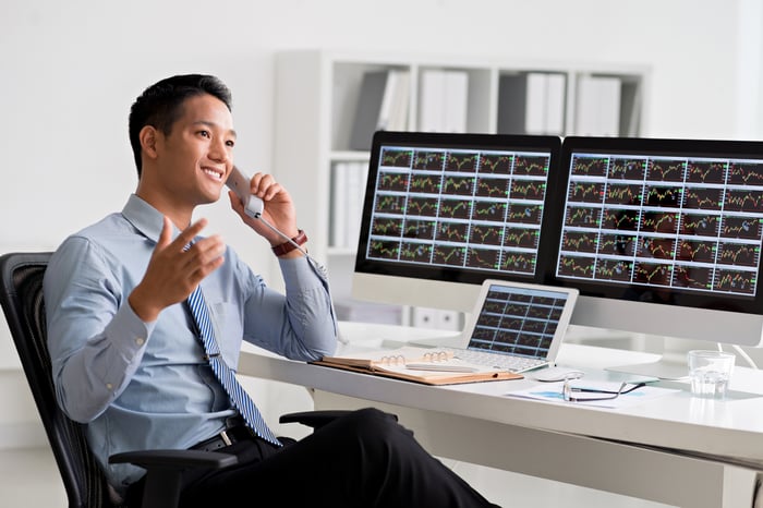 A smiling financial manager talking on telephone.