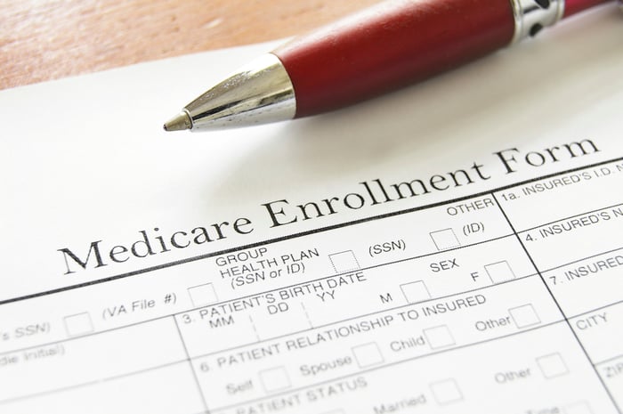 Close up of Medicare enrollment form, with part of pen showing, too