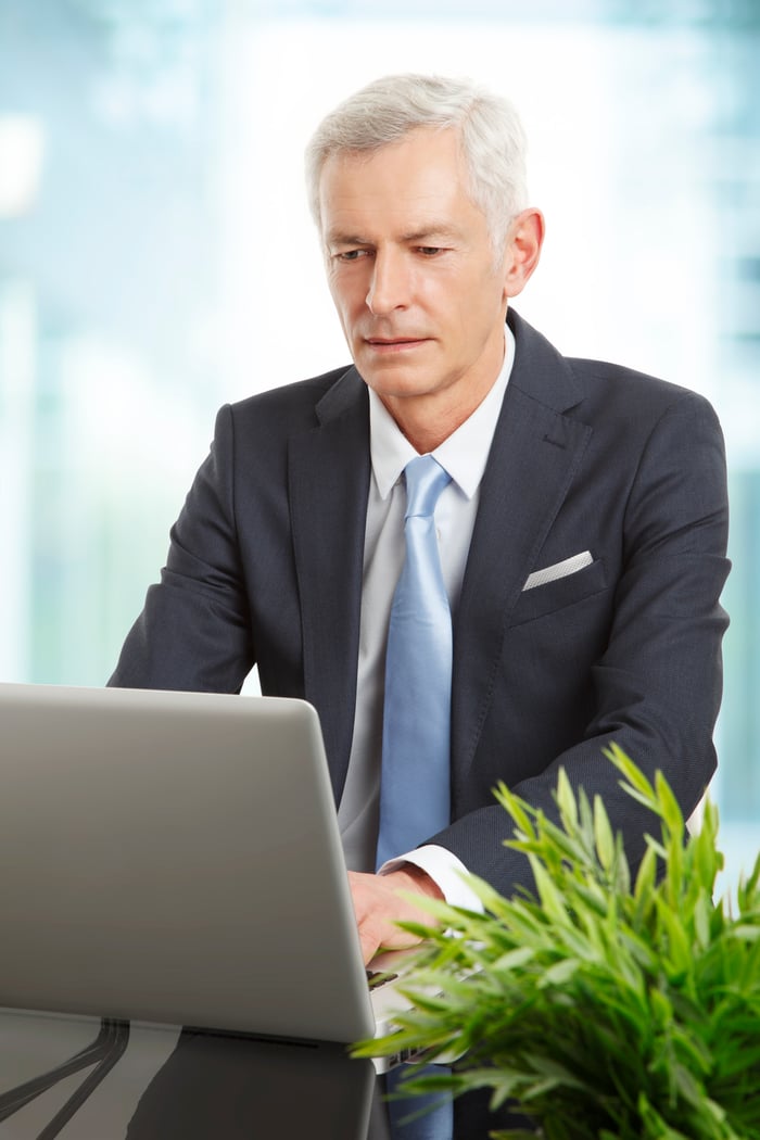 Professional man in a suit and tie on a laptop.