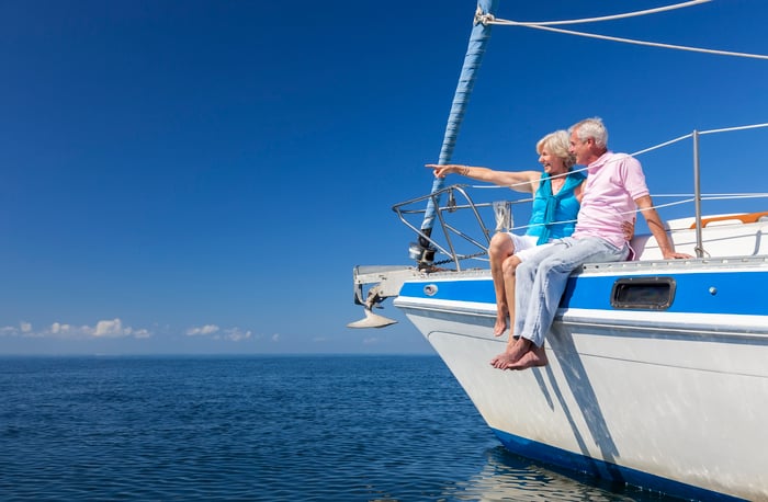 Senior couple sitting on sailboat