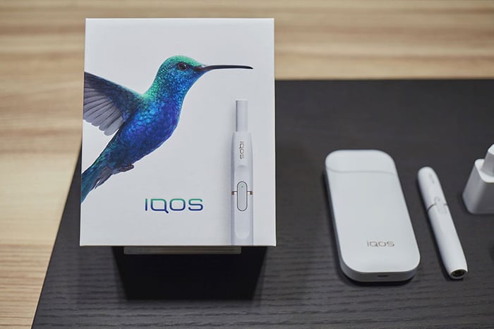 The iQOS heat-not-burn device, including packaging and components.