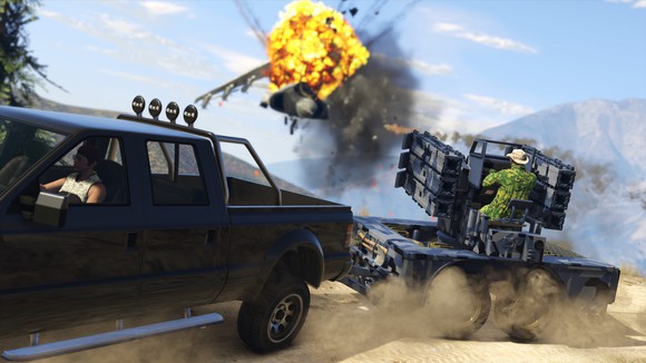 A truck towing a person manning a gun turret in Grand Theft Auto V.