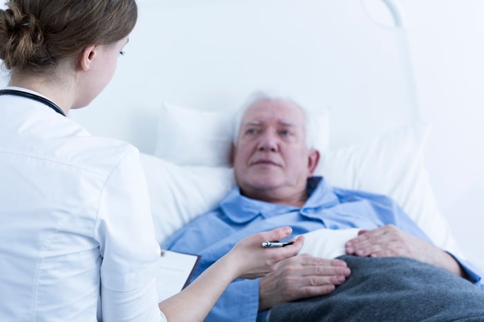 Senior male patient talking to a nurse