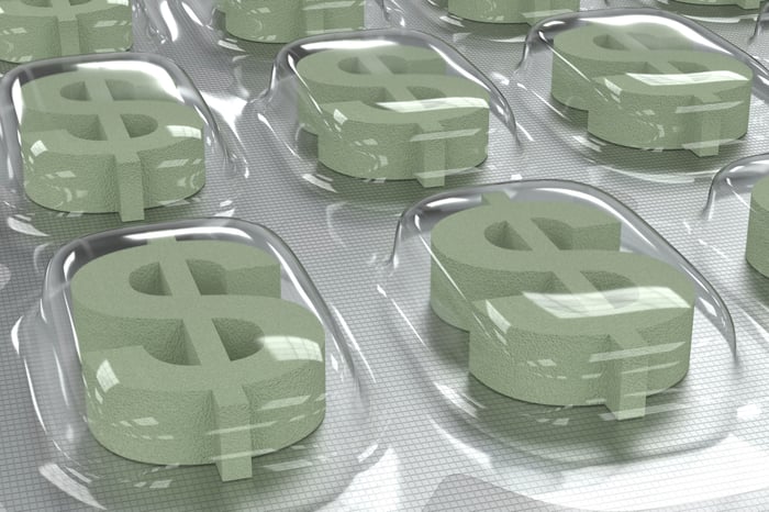 Drug packaging with dollar signs in place of pills. 