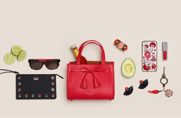 A Kate Spade web ad, featuring a purse, sunglasses, and several other accessories.