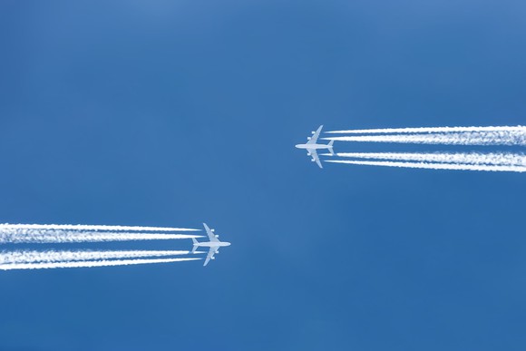 Two airplanes flying toward one another