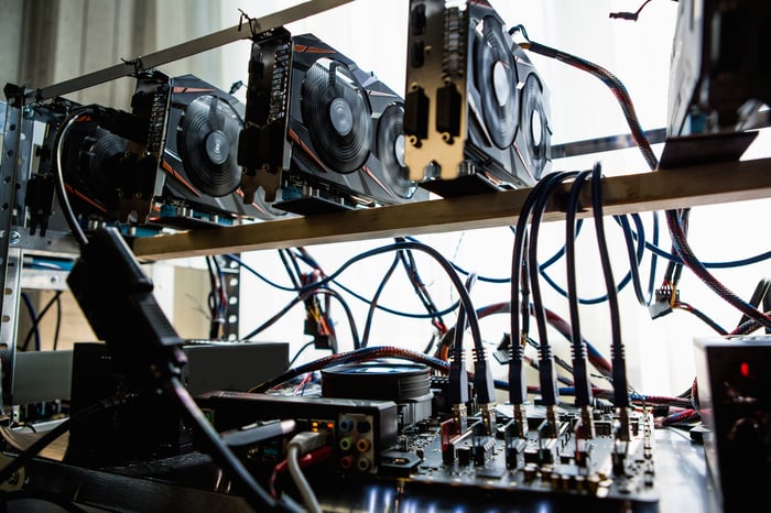 A computer with multiple hard drives and graphic cards operating by a cryptocurrency miner. 