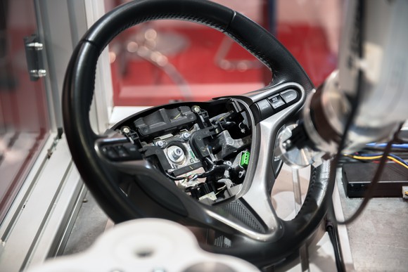 A robotic arm building a car steering wheel.