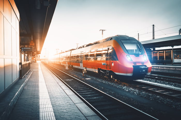 Modern high speed red commuter train at the railway station.