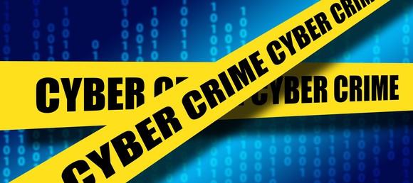 Cyber Crime yellow tape over blue digits background.