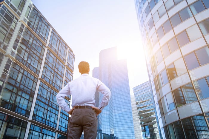 Man looking up at an office building