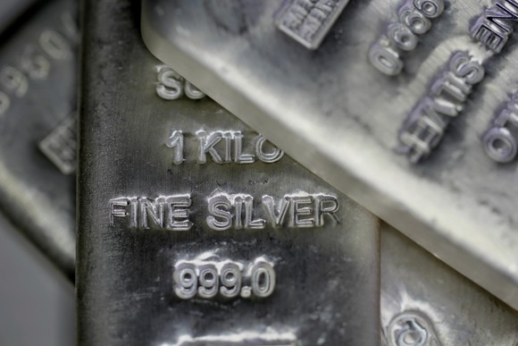 Silver kilogram bars stamped with "fine silver" and "999.0" purity stamps.