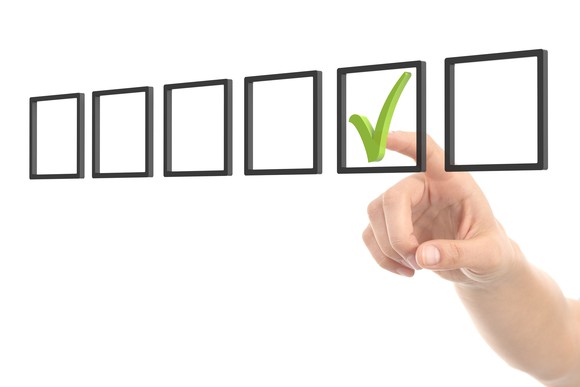 six square boxes with a hand pointing to one of them that has a green checkmark in it