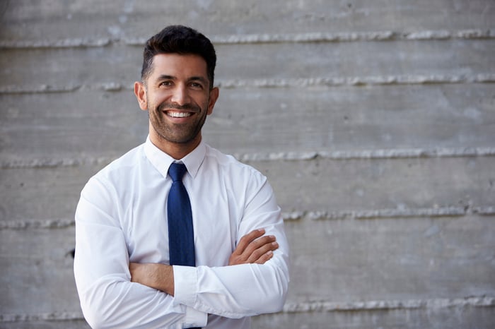 Smiling man in collared shirt and tie