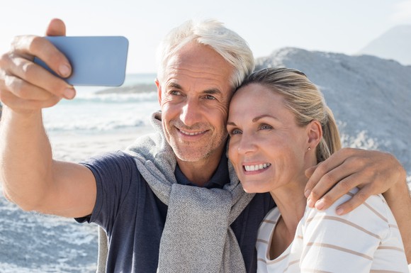 Older couple taking a selfie amidst a scenic backdrop