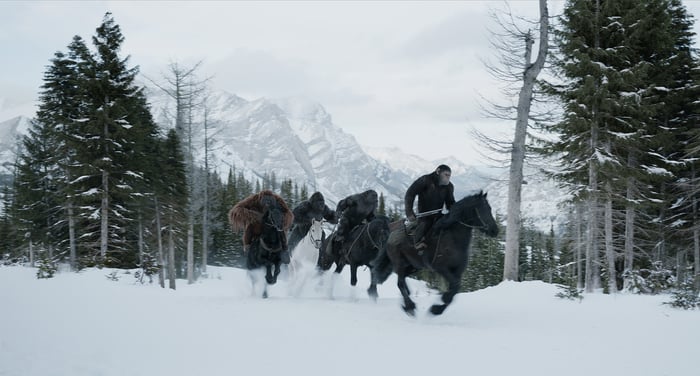 Apes riding horses across a snowy landscape in Fox's "War for the Planet of the Apes."