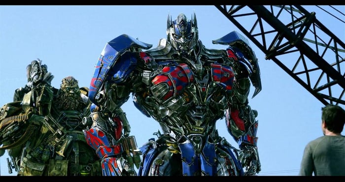 Character looking at Optimus Prime and another transformer in Viacom's "Transformers: The Last Knight."