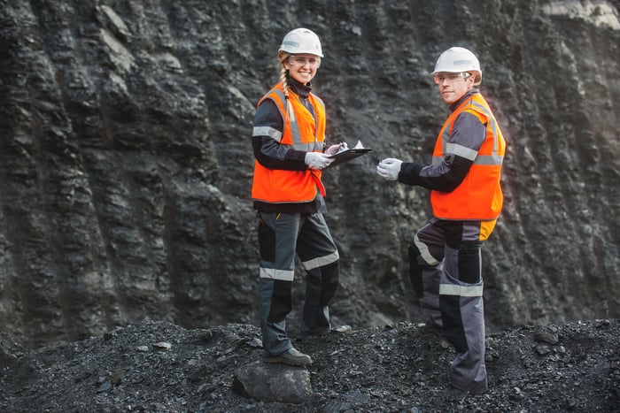 Two miners standing in a mine