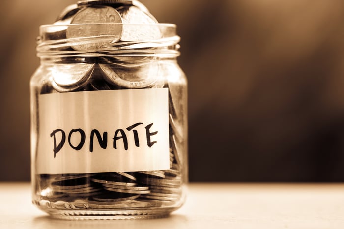 glass jar full of cois with donate written on it