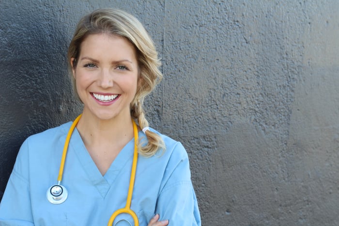 Smiling woman in scrubs