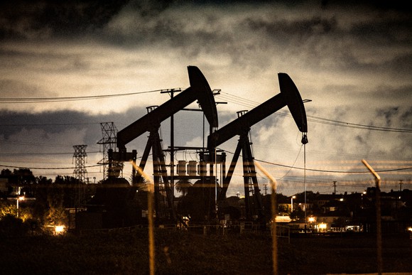 Two oil pumps at dusk.
